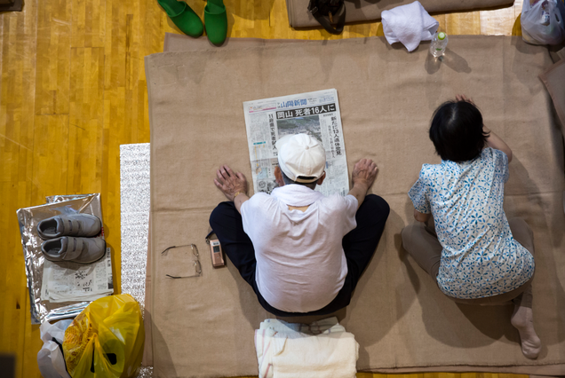 Survivors of the storm stake out in a temporary shelter.